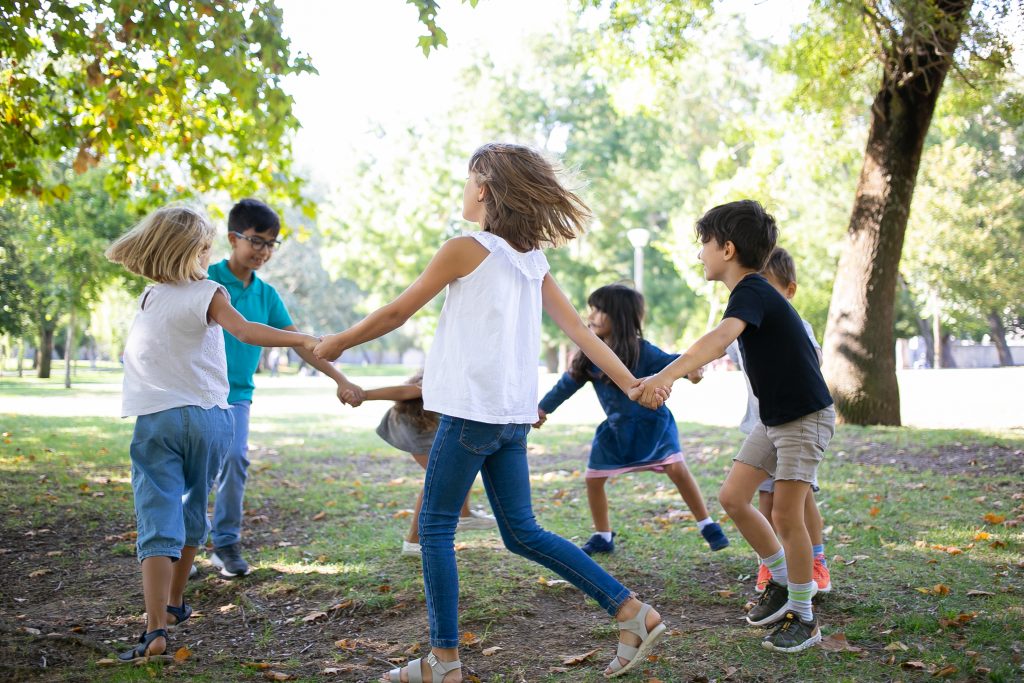 group children holding hands dancing around enjoying outdoor activities having fun park kids party friendship concept - FiZ Leipzig